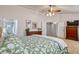 Bright primary bedroom featuring a ceiling fan, and an ensuite bathroom with glass-doored shower at 10824 Quail Ridge Dr, Parker, CO 80138