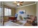 Bright home office features hardwood floors, natural light from the window, and an area rug at 10824 Quail Ridge Dr, Parker, CO 80138
