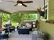 Inviting covered porch with comfortable seating, ceiling fan, and a view of the outdoors at 10824 Quail Ridge Dr, Parker, CO 80138