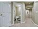 View of powder room with tiled floor, white fixtures and neutral walls at 10824 Quail Ridge Dr, Parker, CO 80138