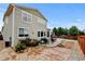 Spacious backyard featuring a fire pit, patio with outdoor dining, and lush landscaping at 282 Vialpando St, Brighton, CO 80601