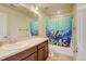 Hall bathroom features a vanity, shower-tub combination, and a colorful under-the-sea themed shower curtain at 282 Vialpando St, Brighton, CO 80601