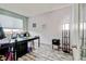 Home office or bedroom with hardwood floors, large windows, and neutral paint colors at 282 Vialpando St, Brighton, CO 80601