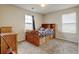 Cozy bedroom with natural light, built-in shelving, wood furnishings, and plush carpeting at 282 Vialpando St, Brighton, CO 80601
