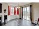 Bright dining area featuring hardwood floors, a modern chandelier, large windows, and access to the backyard at 282 Vialpando St, Brighton, CO 80601