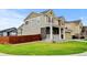 Charming two-story home featuring stone accents, a welcoming front porch, and a well-manicured lawn at 282 Vialpando St, Brighton, CO 80601
