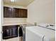 Convenient laundry room featuring updated machines, built in cabinetry, and ample counter space at 282 Vialpando St, Brighton, CO 80601