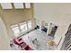 A high angle shows the vaulted ceilings, fireplace, hardwood floors, and furniture in a sunny living room at 282 Vialpando St, Brighton, CO 80601
