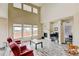 Bright living room boasts vaulted ceilings, a fireplace, and large windows overlooking the landscaped yard at 282 Vialpando St, Brighton, CO 80601