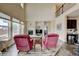 Inviting living room features a fireplace, hardwood floors, and large windows that provide plenty of sunlight at 282 Vialpando St, Brighton, CO 80601
