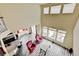 Great view of an open concept living space with a high ceiling, hardwood floors, and adjacent kitchen at 282 Vialpando St, Brighton, CO 80601