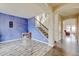 Bright living room boasts hardwood floors, staircase, and a statement wall, creating a modern and inviting space at 282 Vialpando St, Brighton, CO 80601