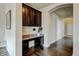 Office featuring dark hardwood floors, granite countertop desk, and dark cabinetry, enhancing style and functionality at 282 Vialpando St, Brighton, CO 80601