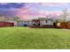 Spacious backyard featuring a well-kept lawn, wooden deck with pergola, and privacy fence at 7286 Wolff St, Westminster, CO 80030