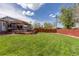Expansive backyard with green lawn, wooden deck, and privacy fence, perfect for outdoor activities at 7286 Wolff St, Westminster, CO 80030