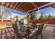 Inviting backyard patio with a wooden pergola, dining set, and ample seating at 7286 Wolff St, Westminster, CO 80030