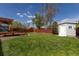 Spacious backyard featuring a well-maintained lawn, storage shed, and a charming wooden fence for added privacy at 7286 Wolff St, Westminster, CO 80030