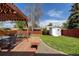 Lush backyard featuring a well-maintained lawn, wooden deck, and a storage shed at 7286 Wolff St, Westminster, CO 80030