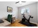 Functional bedroom with a wood desk, peloton, and natural light from a window at 7286 Wolff St, Westminster, CO 80030