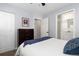 Bright bedroom featuring closet, chest of drawers, white walls, carpet, and a door leading to the bathroom at 7286 Wolff St, Westminster, CO 80030