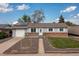Charming single-story home with brick accents, solar panels, and well-manicured front yard at 7286 Wolff St, Westminster, CO 80030