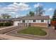 Charming single-story home with brick accents, solar panels, and well-manicured front yard at 7286 Wolff St, Westminster, CO 80030