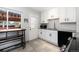 Bright kitchen featuring white cabinets, subway tile backsplash, and granite countertops at 7286 Wolff St, Westminster, CO 80030