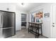 Bright kitchen with white cabinets, stainless steel appliances, and a breakfast nook at 7286 Wolff St, Westminster, CO 80030