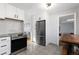 Bright kitchen featuring white cabinets, stainless steel appliances, and tile flooring at 7286 Wolff St, Westminster, CO 80030