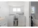 Laundry room with washer, dryer, and plenty of natural light from window at 7286 Wolff St, Westminster, CO 80030
