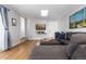 Cozy living room has a large sectional, mounted television, and natural light at 7286 Wolff St, Westminster, CO 80030