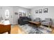 Inviting living room with neutral tones, a decorative rug, and comfortable seating near the entryway at 7286 Wolff St, Westminster, CO 80030