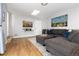 Inviting living room with a large sectional, wood floors, and a mounted television at 7286 Wolff St, Westminster, CO 80030
