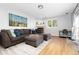 Cozy living room features a large sectional sofa, fireplace, and natural light from the window at 7286 Wolff St, Westminster, CO 80030