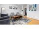 Cozy living area featuring a modern rug, gray seating, and an industrial-style coffee table at 7286 Wolff St, Westminster, CO 80030