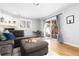 Cozy living room with a comfortable couch, sliding doors to the backyard, and fireplace at 7286 Wolff St, Westminster, CO 80030