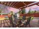 Outdoor patio with wooden pergola, glass table, and outdoor seating at 7286 Wolff St, Westminster, CO 80030
