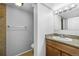 Well-lit bathroom featuring granite countertop vanity and adjacent toilet and shower area with tile accents at 17698 E Loyola Dr # E, Aurora, CO 80013
