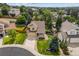 This aerial view showcases a home with a large yard, mature trees, and inviting curb appeal at 10530 Mount Columbia Pl, Parker, CO 80138