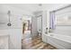 Bright bathroom featuring a bathtub with wood-look flooring and natural light at 10530 Mount Columbia Pl, Parker, CO 80138