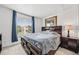 Cozy bedroom featuring a dark wood bed frame and matching nightstand, plus natural light at 10530 Mount Columbia Pl, Parker, CO 80138