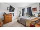 Comfortable bedroom featuring mounted TV, a bed, and natural light at 10530 Mount Columbia Pl, Parker, CO 80138