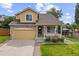 Charming two-story home with a welcoming front porch and well-maintained lawn and attached two car garage at 10530 Mount Columbia Pl, Parker, CO 80138