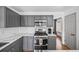 Well-lit kitchen with stainless steel appliances, sleek countertops, and gray cabinets at 10530 Mount Columbia Pl, Parker, CO 80138