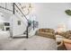 Open-concept living area with staircase, vaulted ceiling, and two comfortable sofas at 10530 Mount Columbia Pl, Parker, CO 80138