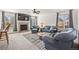 Cozy living room with plush furniture, a fireplace, and abundant natural light from multiple windows at 10530 Mount Columbia Pl, Parker, CO 80138