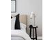 Close up of stylishly decorated bedside table with a lamp, decorations, and a plush bed at 4485 Tennyson St # 5, Denver, CO 80212