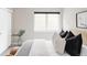 Bedroom featuring a modern black blind, stylishly decorated bed with decorative pillows, and a cozy atmosphere at 4485 Tennyson St # 5, Denver, CO 80212