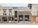 Facade of modern townhomes, featuring brick and neutral siding, large windows, and clearly marked unit numbers at 4485 Tennyson St # 5, Denver, CO 80212
