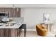 Modern kitchen features a breakfast bar, stainless steel appliances, and contemporary wood cabinetry at 4485 Tennyson St # 5, Denver, CO 80212